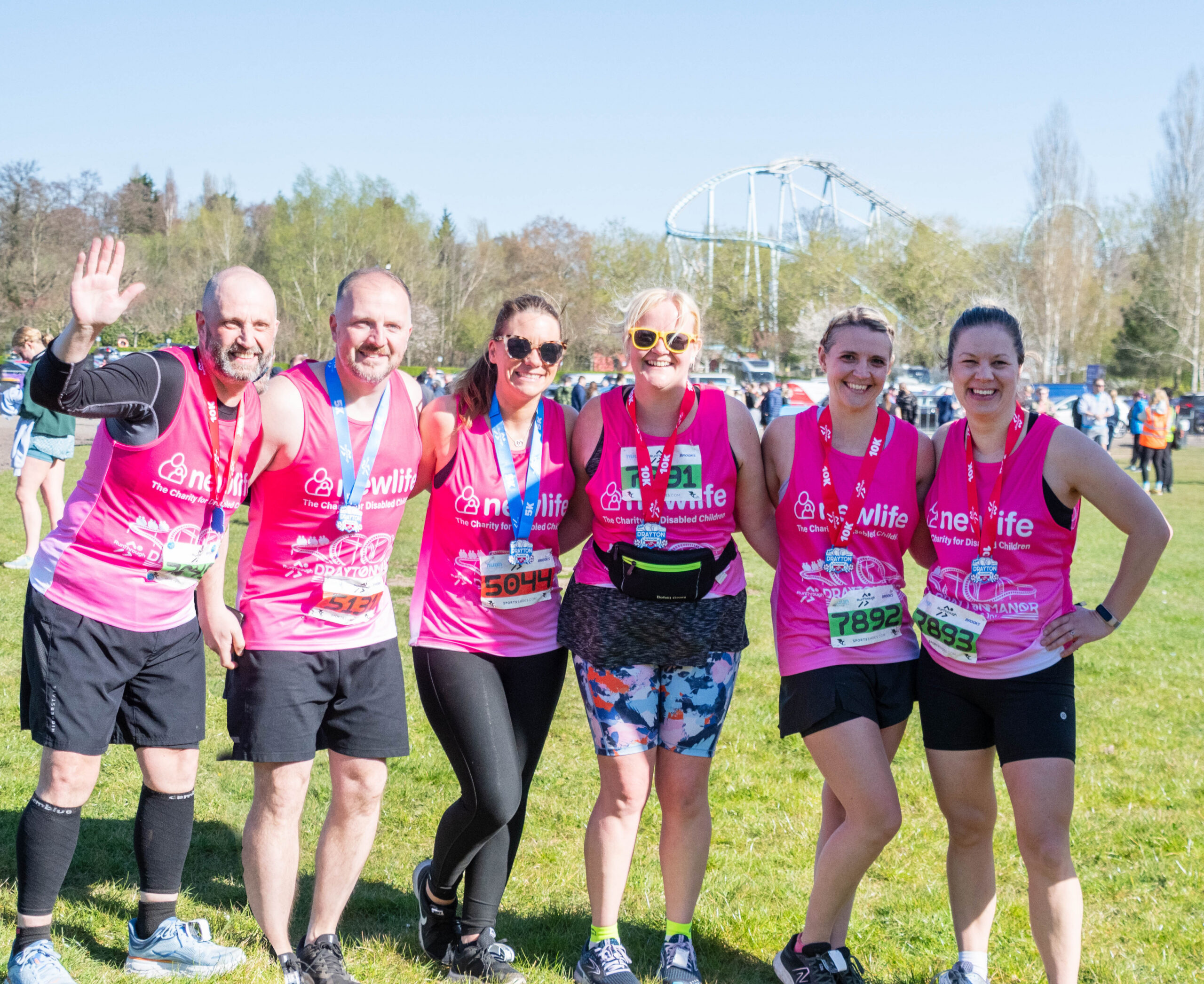 This picture shows a group of 4 females and 2 males celebrating after running a race for Newlife charity.