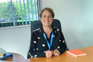 Picture showing Newlife CEO Fiona Robinson sat at her desk