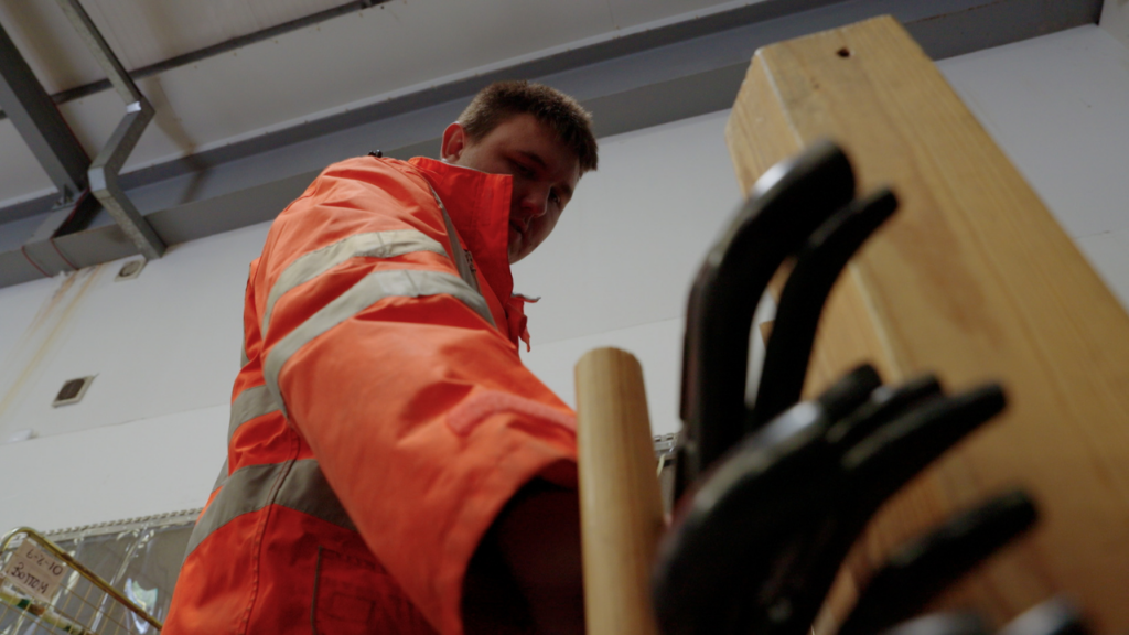 Picture shows a Newlife warehouse volunteer sorting coathangers in the Newlife warehouse.
