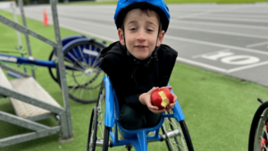 Image shows a child in a specially adapted wheelchairs