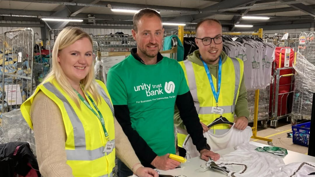 Image shows corporate volunteers in the newlife warehouse
