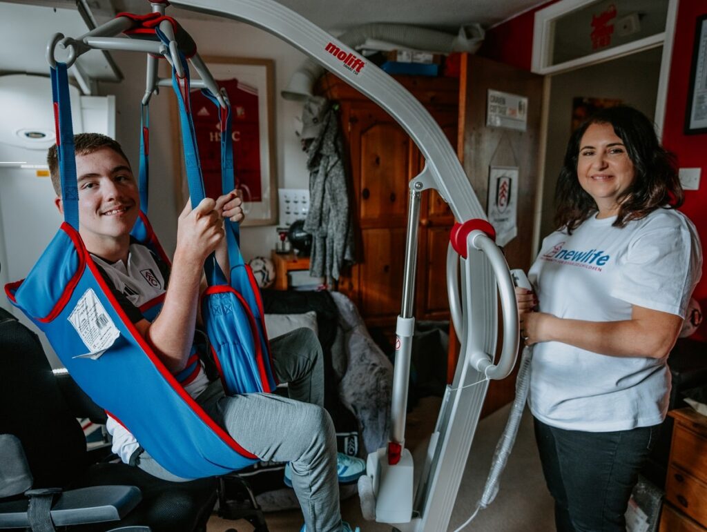 Image shows a teenage child using a hoist